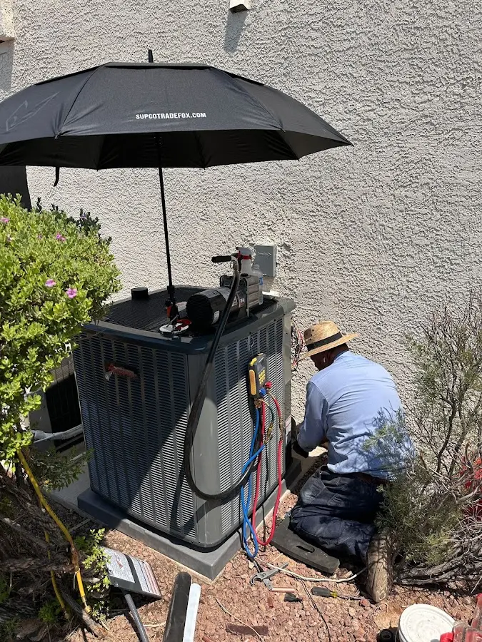 HVAC technician performing outdoor AC maintenance in Rome